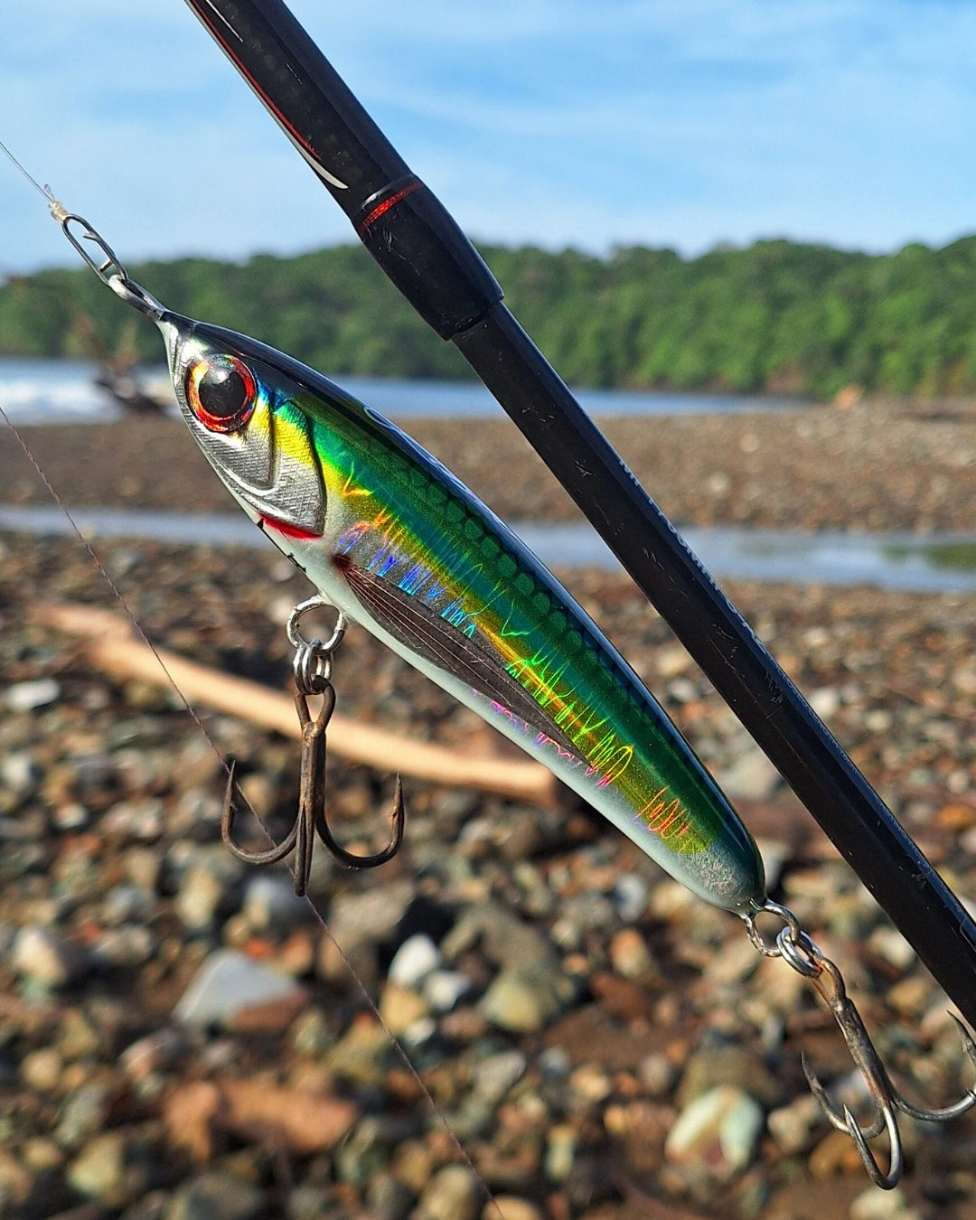 Holographic silver, green and yellow stickbait fishing lure.