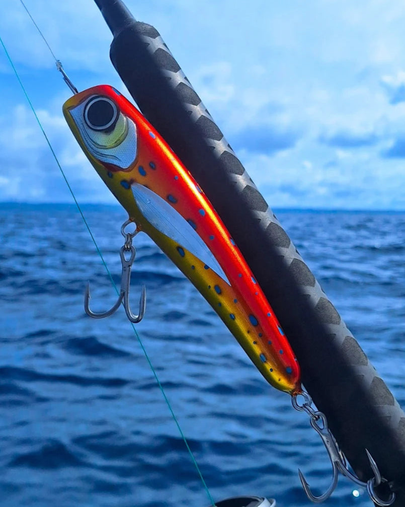 Big orange with blue spots big game offshore fishing lure on a fishing rod ready to catch tuna a d amber jacks.