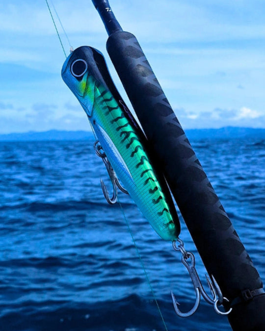 Green mackerel surface popper fishing lure for tuna and sailfish on the boat.